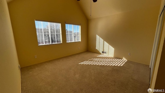 interior space with light carpet, high vaulted ceiling, and a ceiling fan