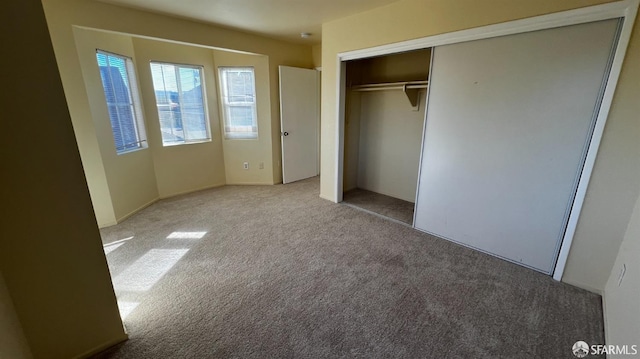 unfurnished bedroom with carpet floors and a closet