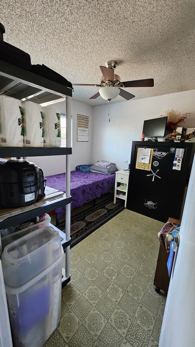 bedroom featuring a textured ceiling and a ceiling fan