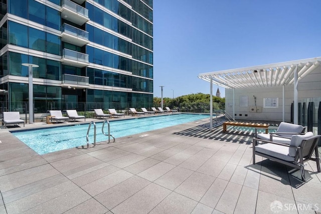 view of pool with a pergola and a patio