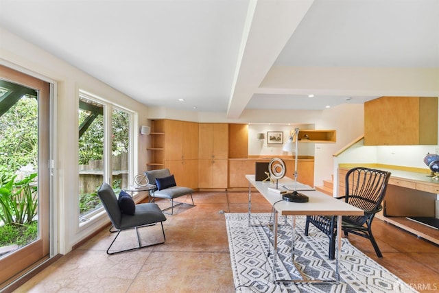 home office featuring concrete flooring and beam ceiling
