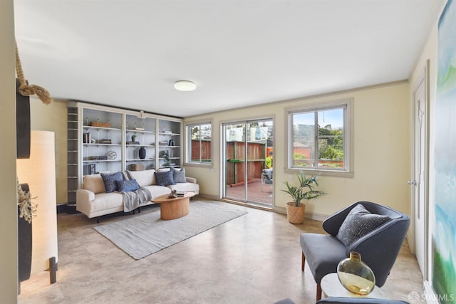 living area featuring concrete flooring and a healthy amount of sunlight