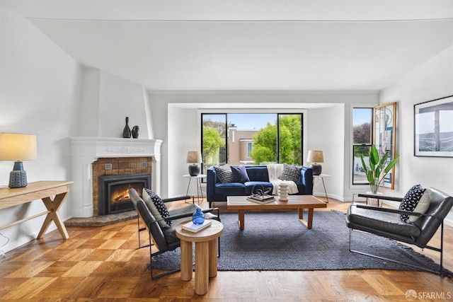 living area featuring a tile fireplace