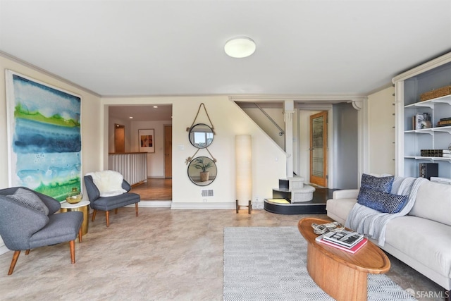 living area with built in features and stairs