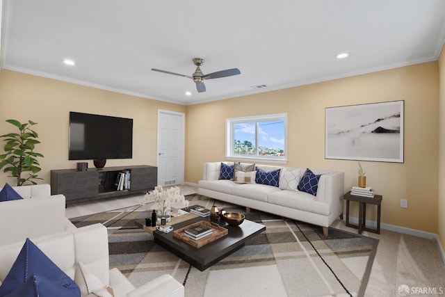 carpeted living room featuring ceiling fan and crown molding