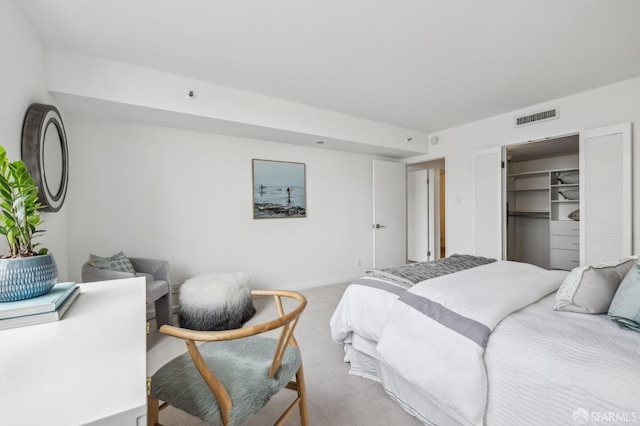 carpeted bedroom with visible vents and baseboards