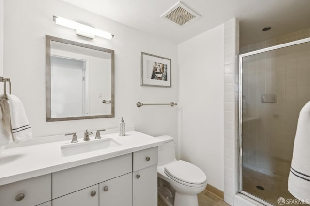 full bath featuring visible vents, toilet, a stall shower, and vanity