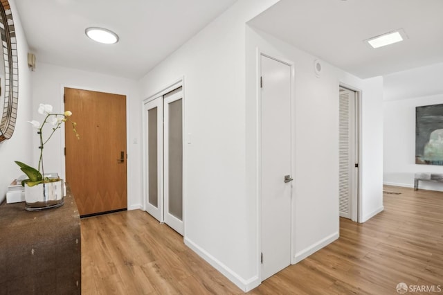 interior space with baseboards and light wood-style floors