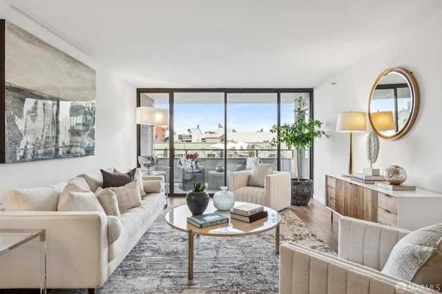 living room with expansive windows and wood finished floors