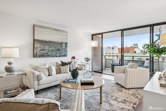 living room featuring a wall of windows, a view of city, and wood finished floors