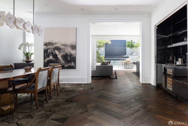 dining room featuring crown molding, dark parquet flooring, and bar area