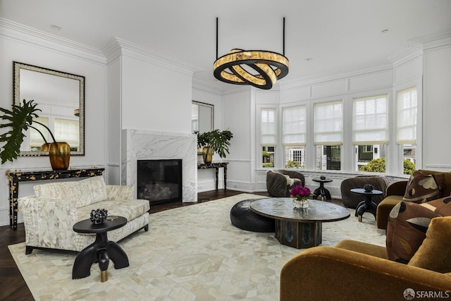 living room with crown molding, a high end fireplace, and dark wood-type flooring