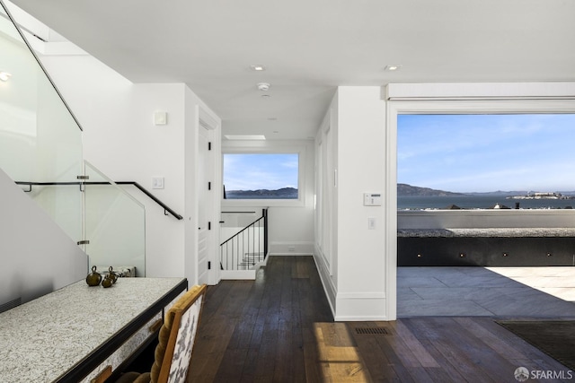 hall with dark hardwood / wood-style flooring and a mountain view