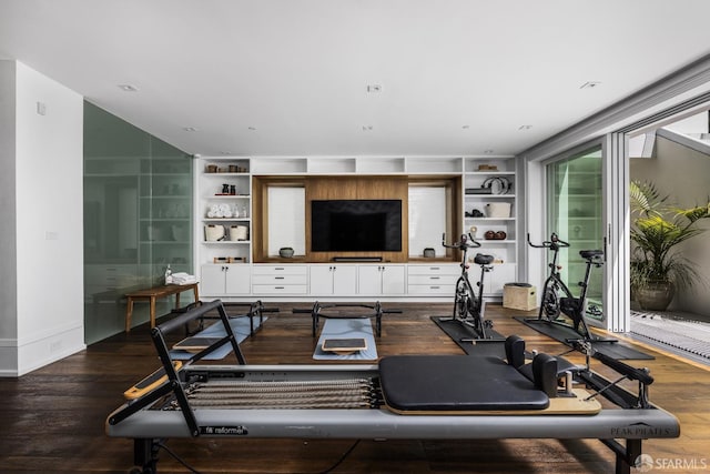 workout area featuring built in shelves and wood-type flooring