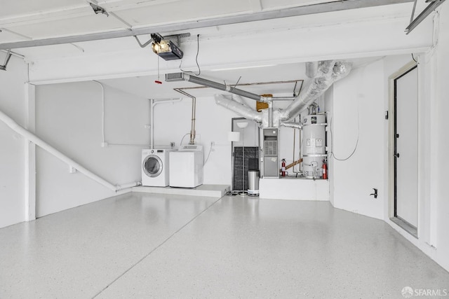 garage featuring strapped water heater, a garage door opener, washing machine and clothes dryer, and heating unit