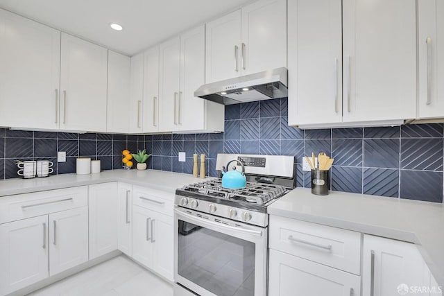 kitchen with gas range, backsplash, and white cabinetry