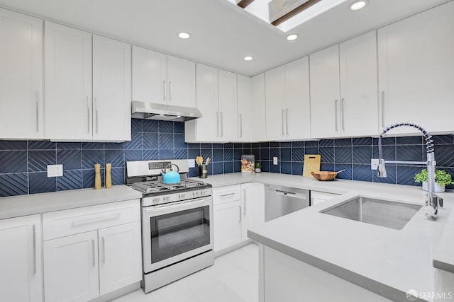 kitchen featuring white cabinets, appliances with stainless steel finishes, sink, and tasteful backsplash