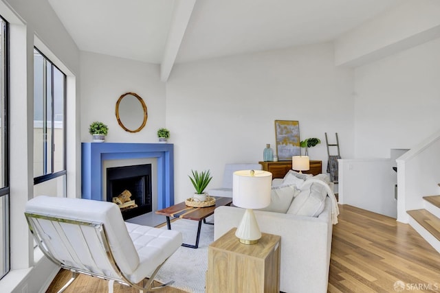 living room featuring light hardwood / wood-style flooring and beam ceiling