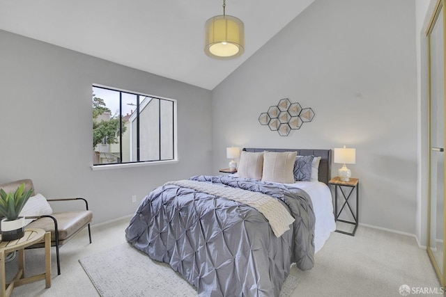 bedroom featuring light carpet and vaulted ceiling