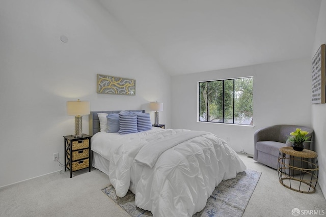 carpeted bedroom with lofted ceiling