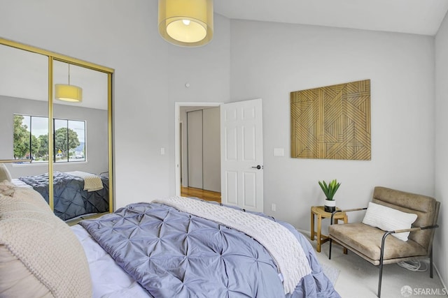 bedroom with vaulted ceiling, a closet, and carpet floors