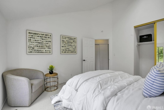 carpeted bedroom featuring vaulted ceiling and a closet