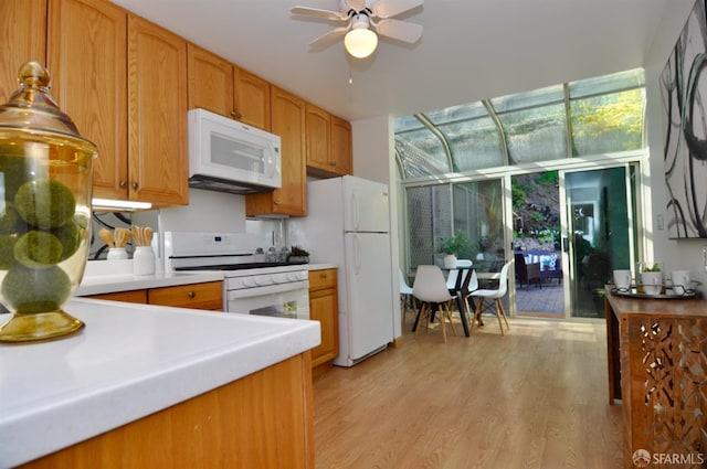 kitchen featuring ceiling fan, light countertops, light wood-style floors, brown cabinetry, and white appliances