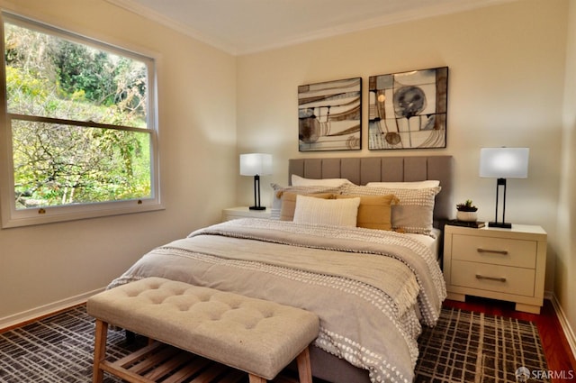 bedroom featuring dark wood-type flooring, baseboards, and ornamental molding