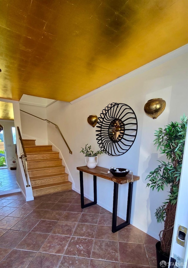 stairs featuring tile patterned flooring and ornamental molding