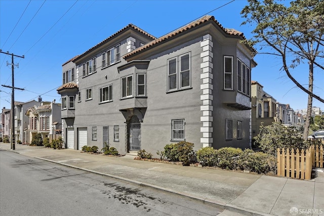 view of building exterior featuring a residential view and a garage