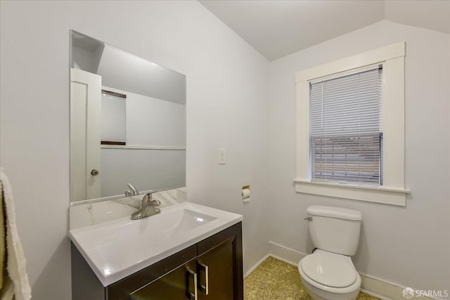 bathroom with vanity, baseboards, toilet, and lofted ceiling