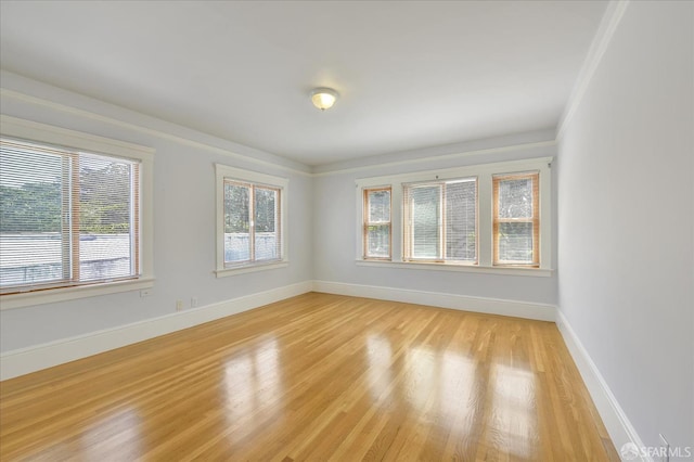 unfurnished room with light wood-style floors and baseboards