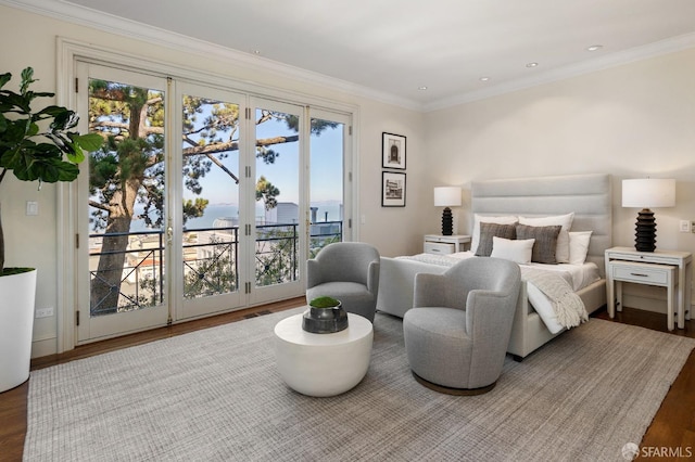 bedroom featuring wood-type flooring, crown molding, and access to exterior