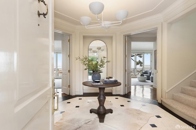 entrance foyer with crown molding and hardwood / wood-style floors