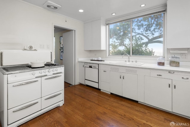 kitchen featuring white cabinets, ornamental molding, sink, white appliances, and dark hardwood / wood-style flooring