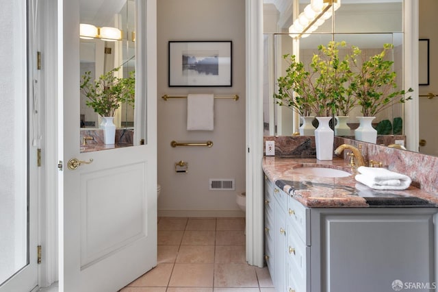 interior space with tile patterned flooring, vanity, and toilet