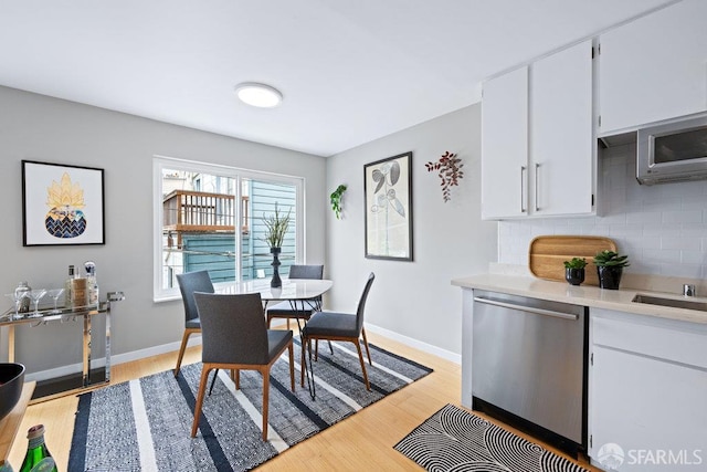 3421 25th St Unit 4, San Francisco, CA 94110 - dining room with light wood-style flooring and baseboards