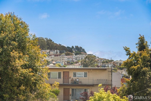 3421 25th St Unit 4, San Francisco, CA 94110 - view of front of house with a balcony, stucco siding, and a residential view