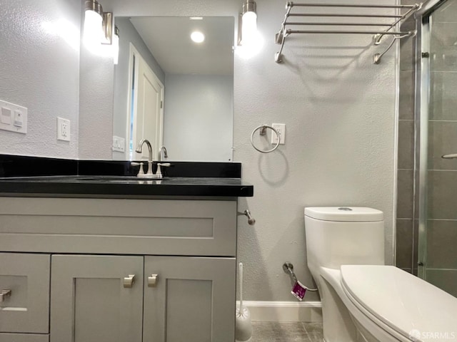 bathroom with vanity, tile patterned flooring, toilet, and an enclosed shower