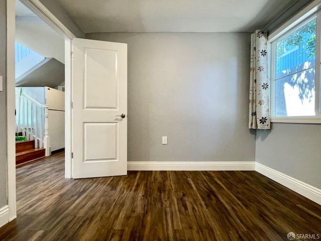 spare room featuring dark wood-type flooring