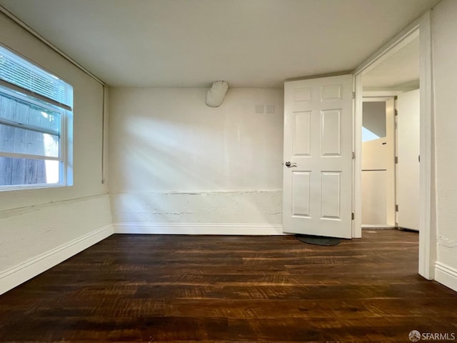 spare room featuring dark hardwood / wood-style flooring