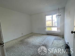 800 N Delaware St Unit 211, San Mateo, CA 94401 - unfurnished room featuring an inviting chandelier and baseboard heating