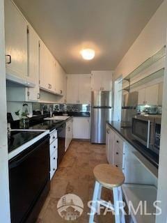 800 N Delaware St Unit 211, San Mateo, CA 94401 - kitchen with appliances with stainless steel finishes, dark countertops, white cabinetry, and under cabinet range hood