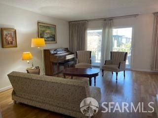 living room with baseboards and wood finished floors