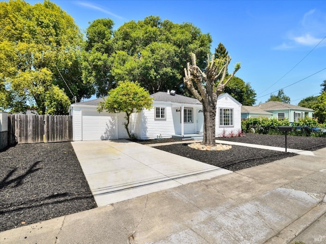 single story home with an attached garage, fence, and concrete driveway