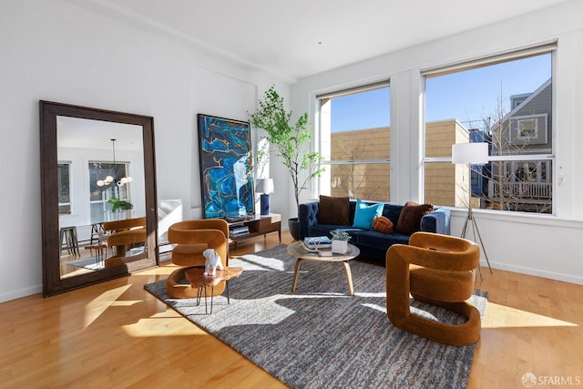 living room featuring wood-type flooring and an inviting chandelier