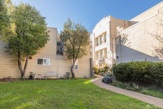 view of side of property with a yard