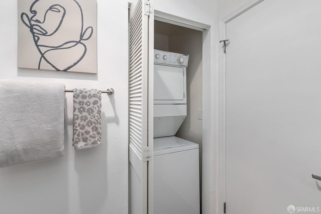 laundry area featuring stacked washer and clothes dryer