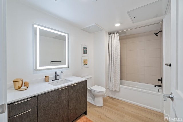 bathroom with shower / bathtub combination with curtain, vanity, toilet, and wood finished floors