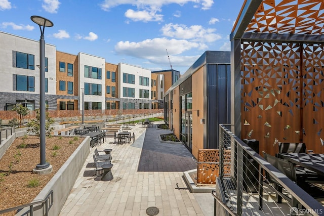 view of community with outdoor dining space and a patio area